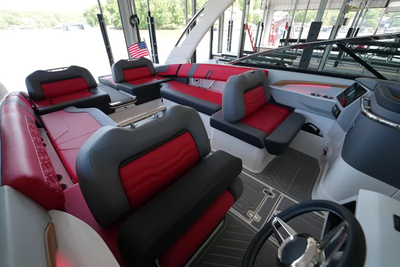  Yacht Photos Pics Luxurious interior of 2025 Regal LS9 boat with red and gray seating.