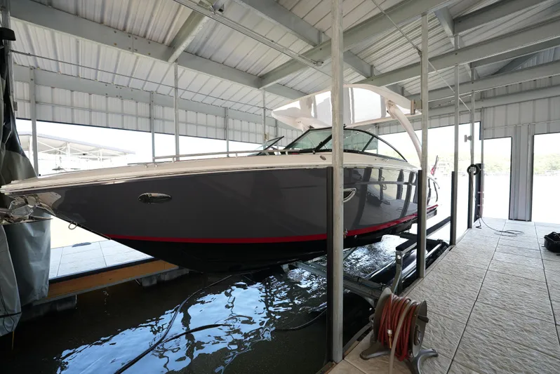  Yacht Photos Pics 2025 Regal LS9 boat docked in a covered marina, side view.