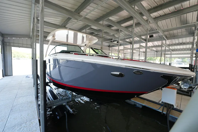  Yacht Photos Pics 2025 Regal LS9 boat in a covered dock, showcasing sleek design and modern features.