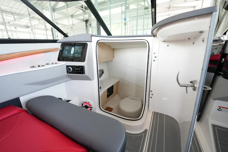  Yacht Photos Pics Interior of 2025 Regal LS9 boat featuring a compact bathroom and modern dashboard.