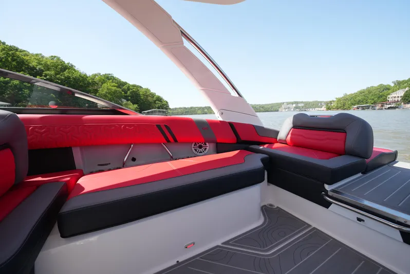  Yacht Photos Pics Luxurious 2025 Regal LS9 boat interior with red and black seating, on a scenic lake.