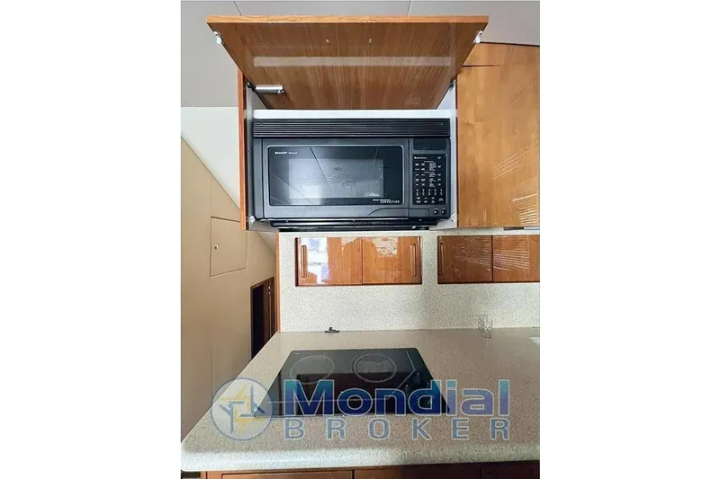  Yacht Photos Pics 2006 Hatteras 50 Convertible yacht kitchen with microwave and stovetop.