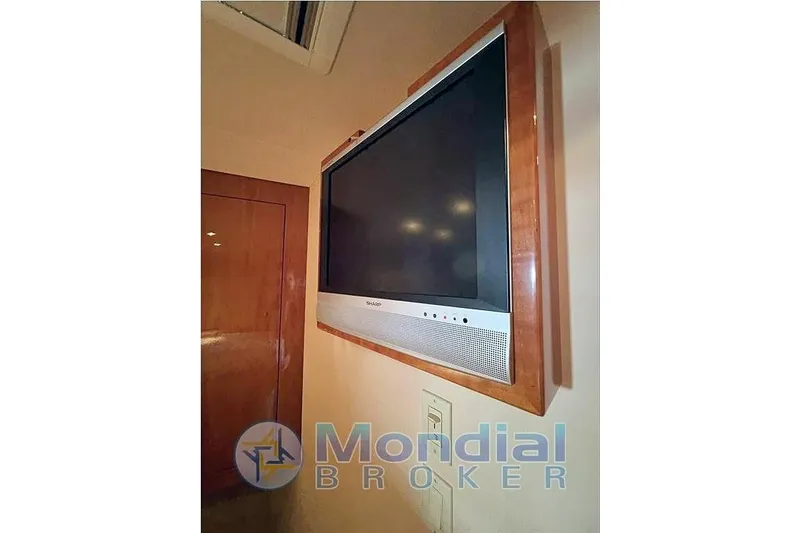  Yacht Photos Pics Wall-mounted TV in 2006 Hatteras 50 Convertible yacht interior.