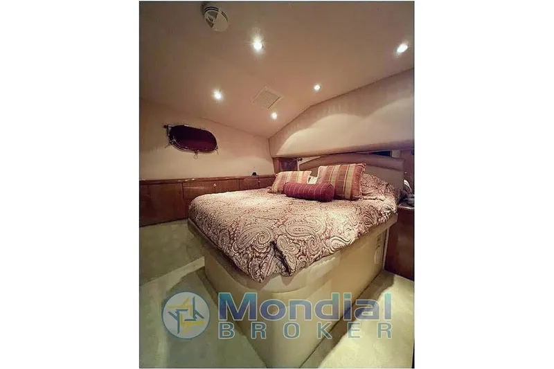  Yacht Photos Pics Luxurious bedroom interior of 2006 Hatteras 50 Convertible yacht with elegant bedding.