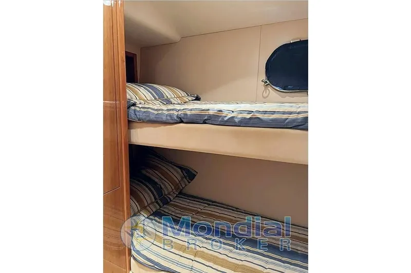  Yacht Photos Pics Bunk beds in 2006 Hatteras 50 Convertible yacht cabin with striped bedding.