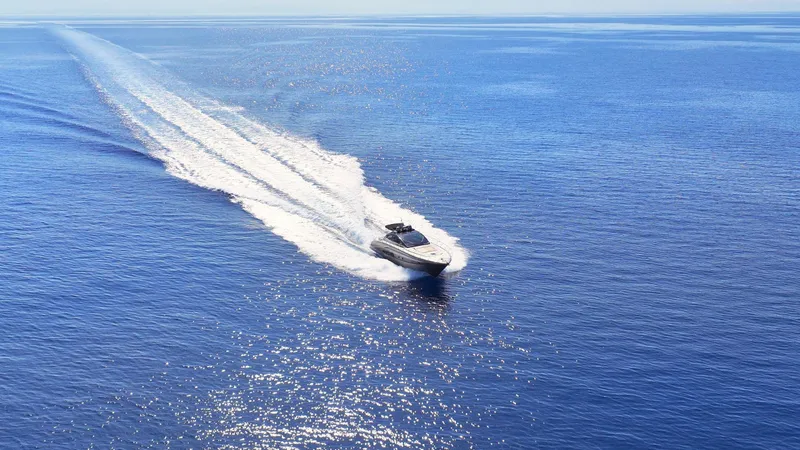 W Yacht Photos Pics 2009 Riva 63 Vertigo yacht cruising on open blue sea.