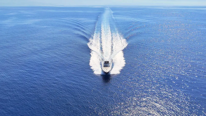 W Yacht Photos Pics Riva 63 Vertigo yacht cruising on open sea, 2009 model, aerial view.