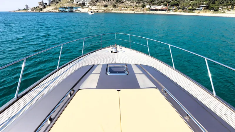 W Yacht Photos Pics Bow view of 2009 Riva 63 Vertigo yacht cruising on clear blue water.