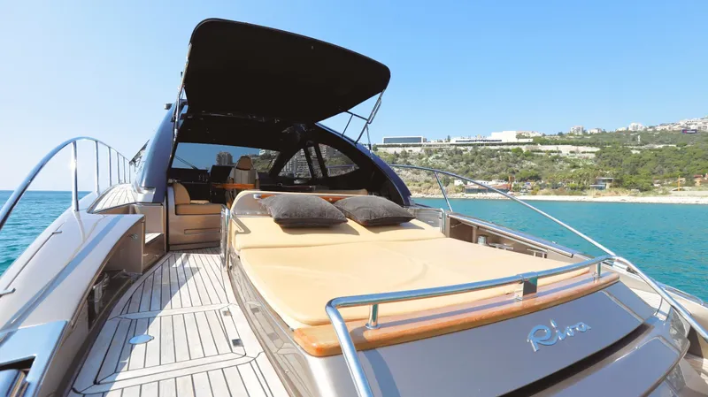 W Yacht Photos Pics Luxurious 2009 Riva 63 Vertigo yacht with sun deck, cruising near scenic coastline.