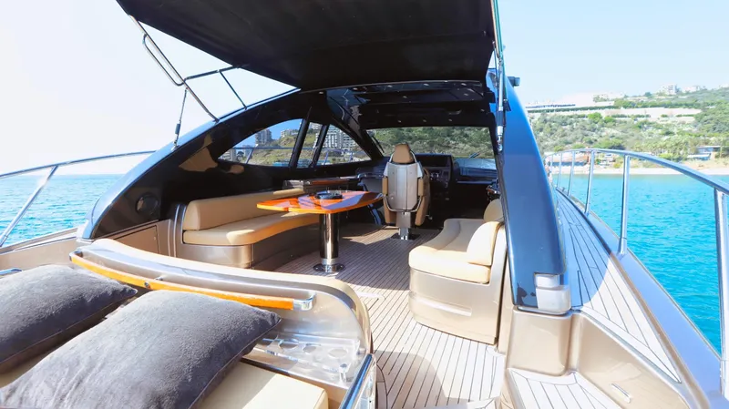 W Yacht Photos Pics Luxurious 2009 Riva 63 Vertigo yacht interior with elegant seating and scenic ocean view.