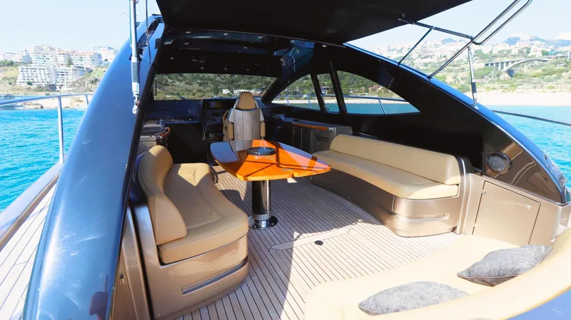 W Yacht Photos Pics Luxurious interior of 2009 Riva 63 Vertigo yacht with elegant seating and scenic ocean view.