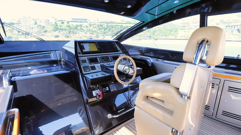 W Yacht Photos Pics Interior of 2009 Riva 63 Vertigo yacht with modern helm and leather seating.