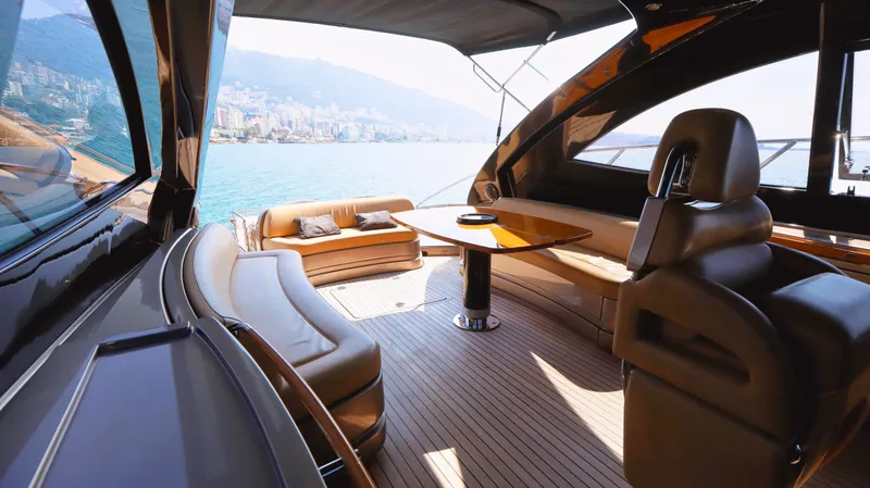 W Yacht Photos Pics Luxurious 2009 Riva 63 Vertigo yacht interior with elegant seating and scenic ocean view.