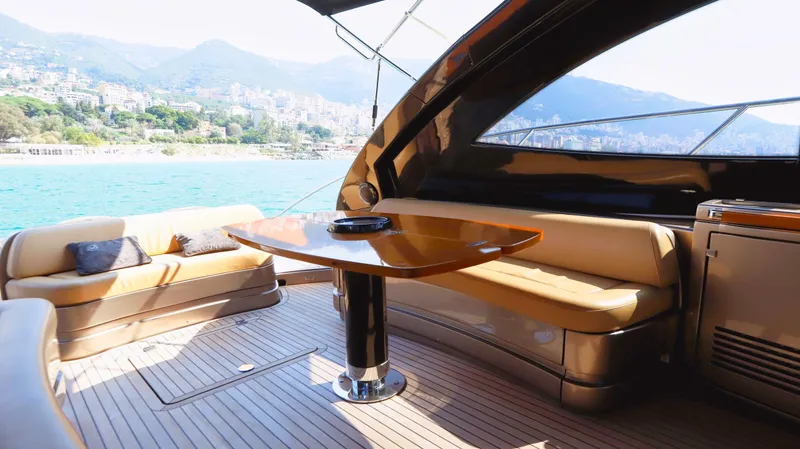 W Yacht Photos Pics Luxurious 2009 Riva 63 Vertigo yacht interior with elegant seating and scenic ocean view.