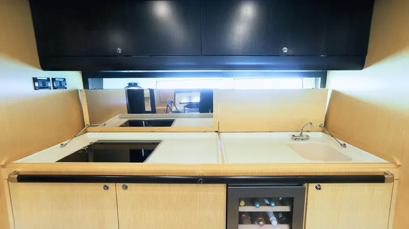 W Yacht Photos Pics Luxurious kitchen interior of 2009 Riva 63 Vertigo yacht with modern appliances and sleek design.