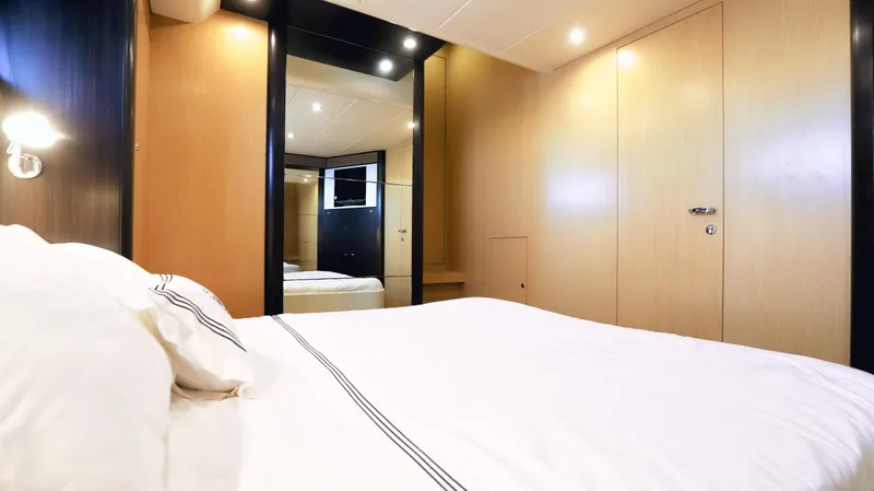 W Yacht Photos Pics Luxurious bedroom interior of 2009 Riva 63 Vertigo yacht with modern design and ambient lighting.