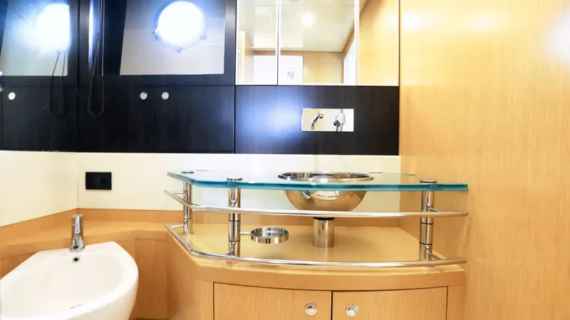 W Yacht Photos Pics Luxurious bathroom interior of 2009 Riva 63 Vertigo yacht with modern sink and fixtures.