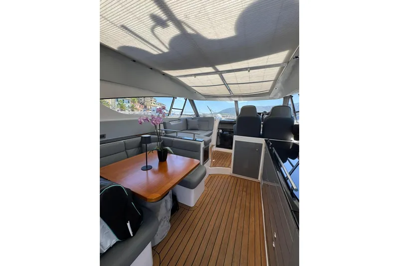  Yacht Photos Pics Luxurious interior of 2012 Elan 48 Power yacht with elegant seating and wooden flooring.