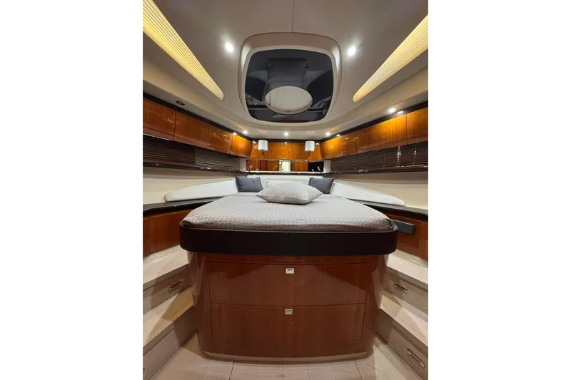  Yacht Photos Pics Luxurious interior of 2012 Elan 48 Power yacht with elegant wood finishes and cozy bedding.