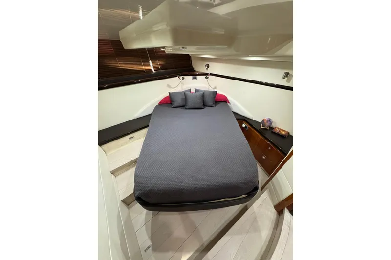  Yacht Photos Pics Luxurious cabin interior of 2012 Elan 48 Power yacht with cozy bed and modern decor.