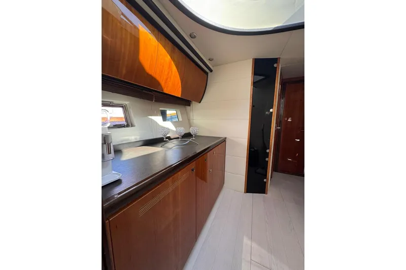  Yacht Photos Pics Interior of 2012 Elan 48 Power yacht with sleek wooden cabinetry and modern design.