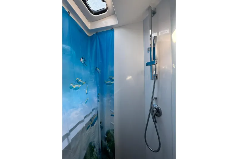  Yacht Photos Pics Shower area in 2012 Elan 48 Power yacht with ocean-themed curtain.