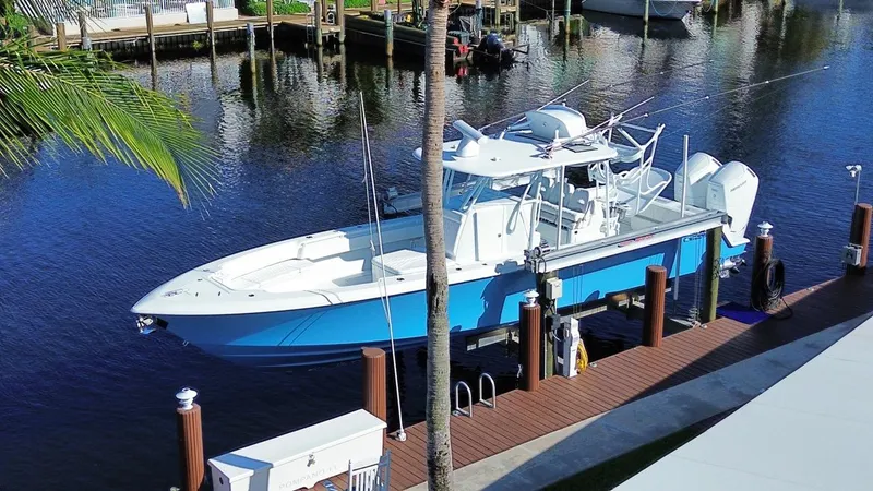  Yacht Photos Pics 2024 Contender 39 ST boat docked on a sunny waterfront.