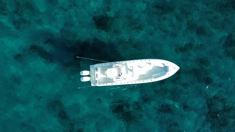  Yacht Photos Pics Aerial view of 2024 Contender 39 ST boat on clear blue water.