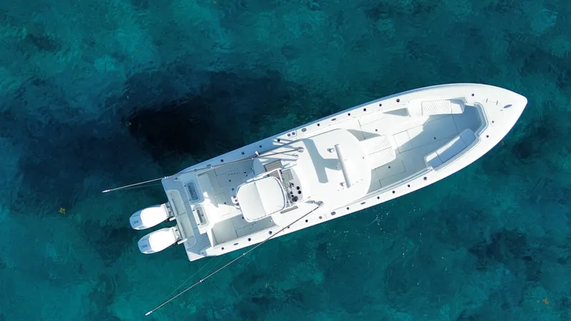  Yacht Photos Pics Aerial view of 2024 Contender 39 ST boat on clear blue water.