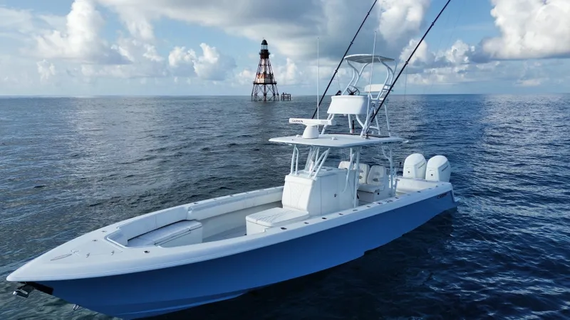  Yacht Photos Pics 2024 Contender 39 ST boat on open sea near a lighthouse under cloudy sky.