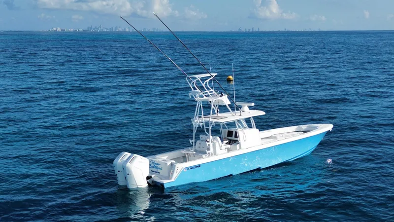  Yacht Photos Pics 2024 Contender 39 ST boat on open ocean with city skyline in background.