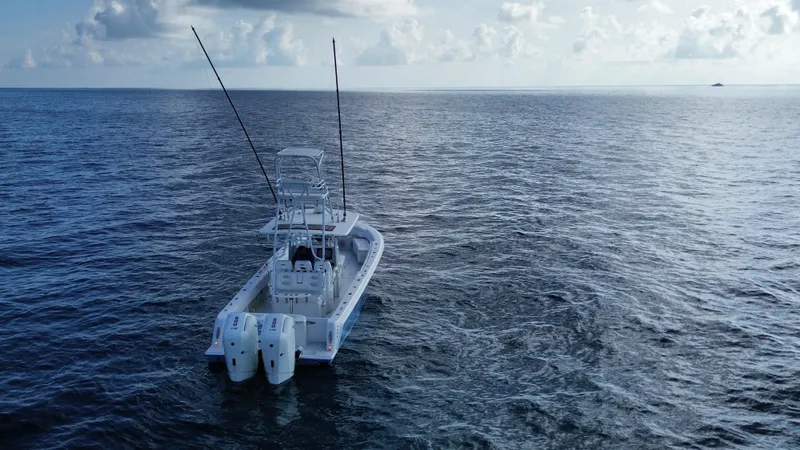  Yacht Photos Pics 2024 Contender 39 ST boat on open ocean, equipped with dual outboard engines.