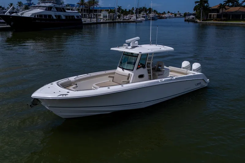 Ducky's Dinghy Yacht Photos Pics 2020 Boston Whaler 330 Outrage boat on calm water near marina.