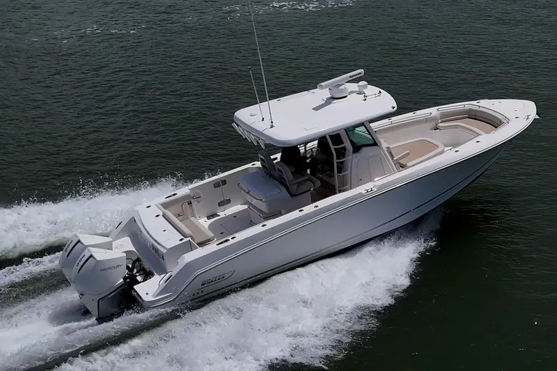Ducky's Dinghy Yacht Photos Pics 2020 Boston Whaler 330 Outrage cruising on open water, showcasing sleek design and powerful engines.