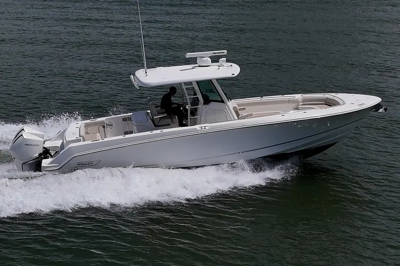 Ducky's Dinghy Yacht Photos Pics 2020 Boston Whaler 330 Outrage cruising on water, side view.