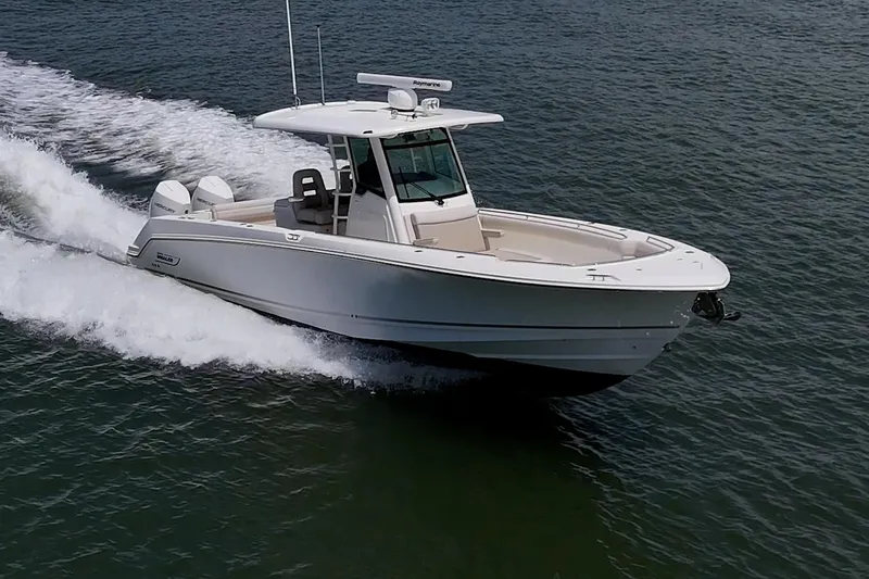 Ducky's Dinghy Yacht Photos Pics 2020 Boston Whaler 330 Outrage cruising on open water, showcasing sleek design and powerful performance.