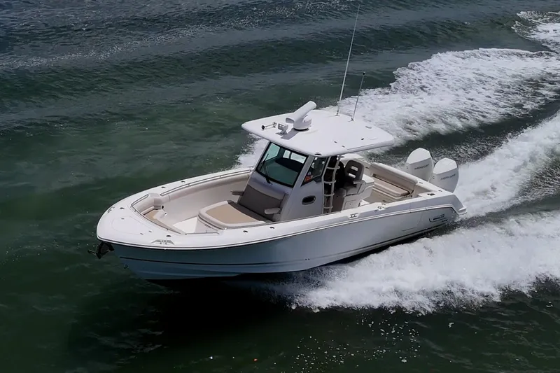 Ducky's Dinghy Yacht Photos Pics 2020 Boston Whaler 330 Outrage cruising on open water, showcasing sleek design and performance.