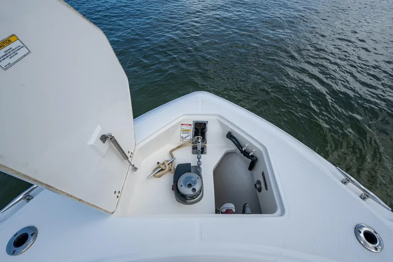 Ducky's Dinghy Yacht Photos Pics 2020 Boston Whaler 330 Outrage anchor compartment with open hatch, showing anchor and chain.
