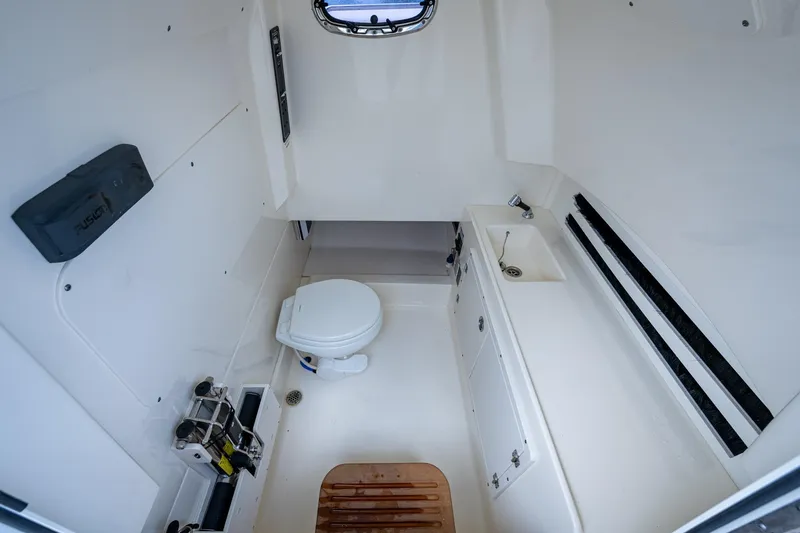 Ducky's Dinghy Yacht Photos Pics 2020 Boston Whaler 330 Outrage cabin interior with toilet and sink.
