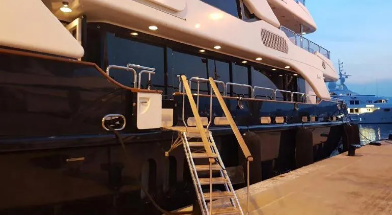  Yacht Photos Pics Luxury yacht Benetti Vision 145, 2010 model, docked at sunset with boarding ladder.