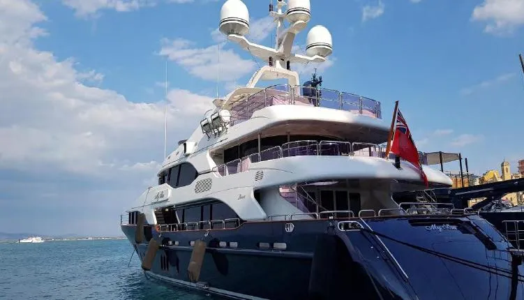  Yacht Photos Pics Luxurious 2010 Benetti Vision 145 yacht docked under a clear blue sky.