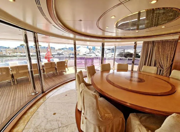  Yacht Photos Pics Luxurious dining area on 2010 Benetti Vision 145 yacht with elegant furnishings and marina view.