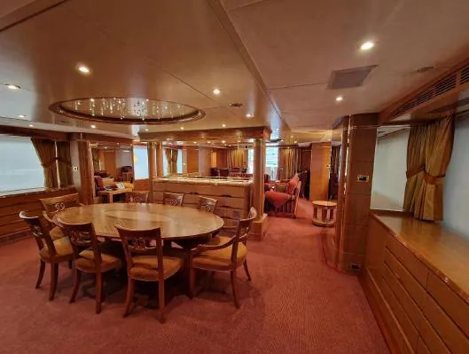  Yacht Photos Pics Luxurious interior of 2010 Benetti Vision 145 yacht with elegant dining area and warm lighting.