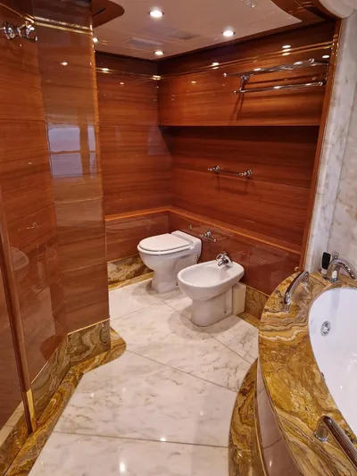  Yacht Photos Pics Luxurious bathroom on 2010 Benetti Vision 145 yacht with wood paneling and marble accents.