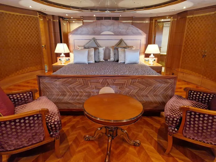  Yacht Photos Pics Luxurious bedroom interior on a 2010 Benetti Vision 145 yacht, featuring elegant wood finishes.