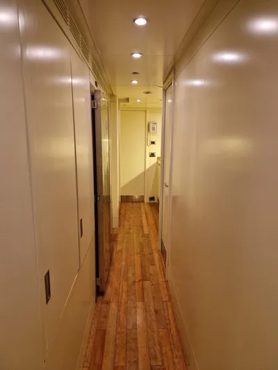  Yacht Photos Pics Narrow hallway with wooden flooring on a 2010 Benetti Vision 145 yacht.