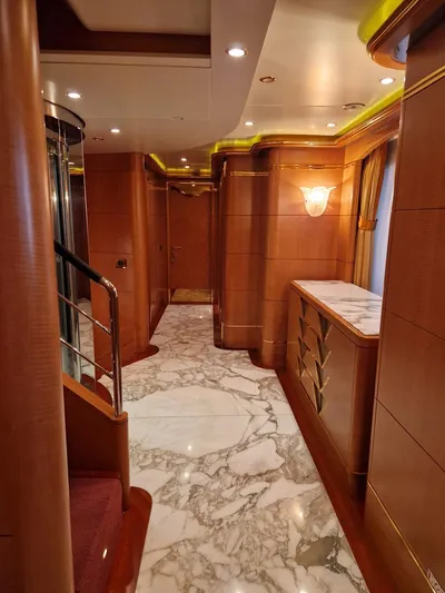  Yacht Photos Pics Luxurious interior of 2010 Benetti Vision 145 yacht with marble flooring and elegant wood paneling.