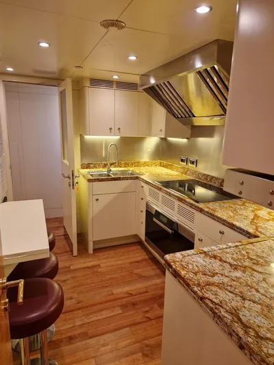  Yacht Photos Pics Luxurious kitchen in 2010 Benetti Vision 145 yacht with granite countertops and modern appliances.