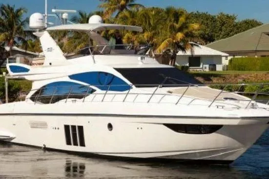 53 Flybridge Yacht Photos Pics 2012 Azimut 53 Flybridge yacht docked near palm trees and houses.