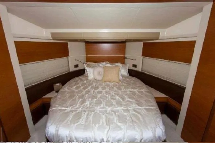 53 Flybridge Yacht Photos Pics Luxurious bedroom interior of 2012 Azimut 53 Flybridge yacht with elegant bedding.